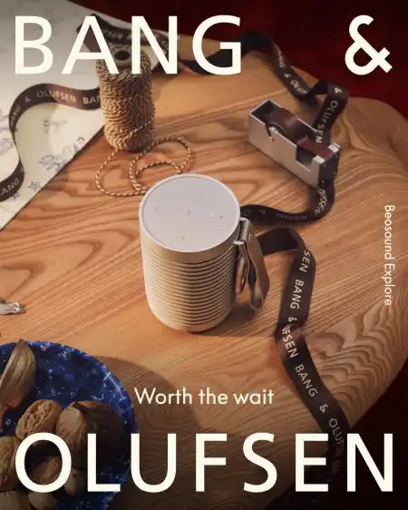 Bang & olufsen speaker with white body and black accents, made of durable plastic.