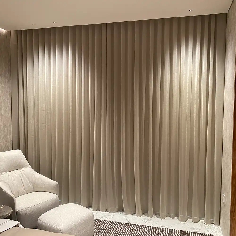 Floor-to-ceiling beige curtains.