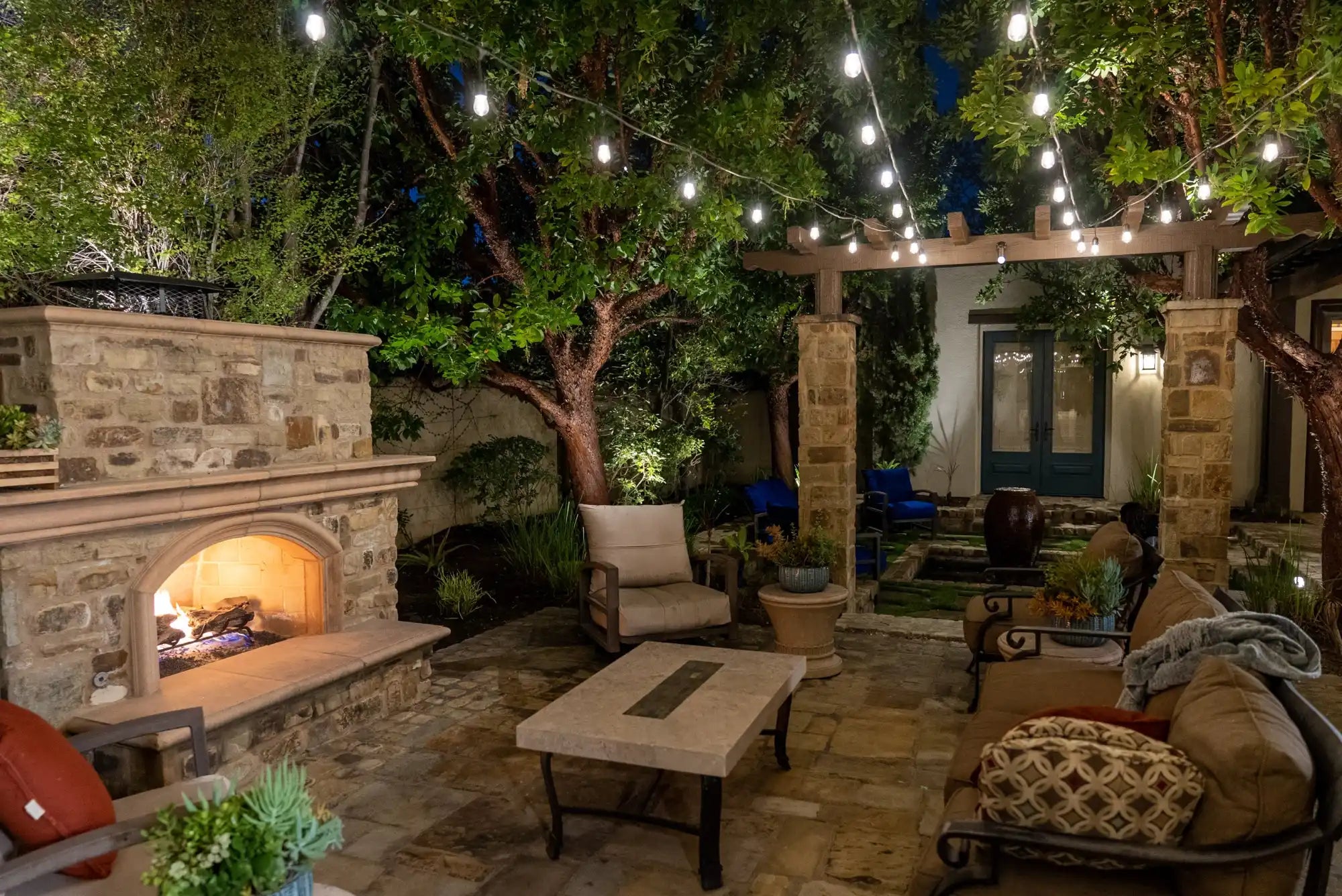 Outdoor living space with stone fireplace.