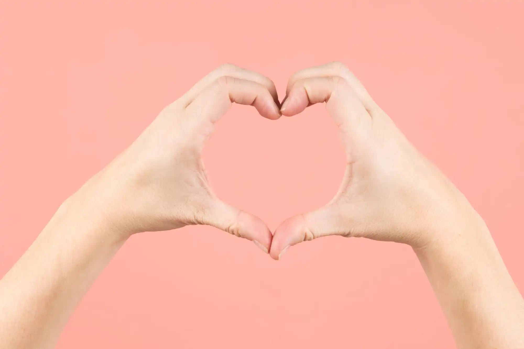 Hands forming a heart shape.