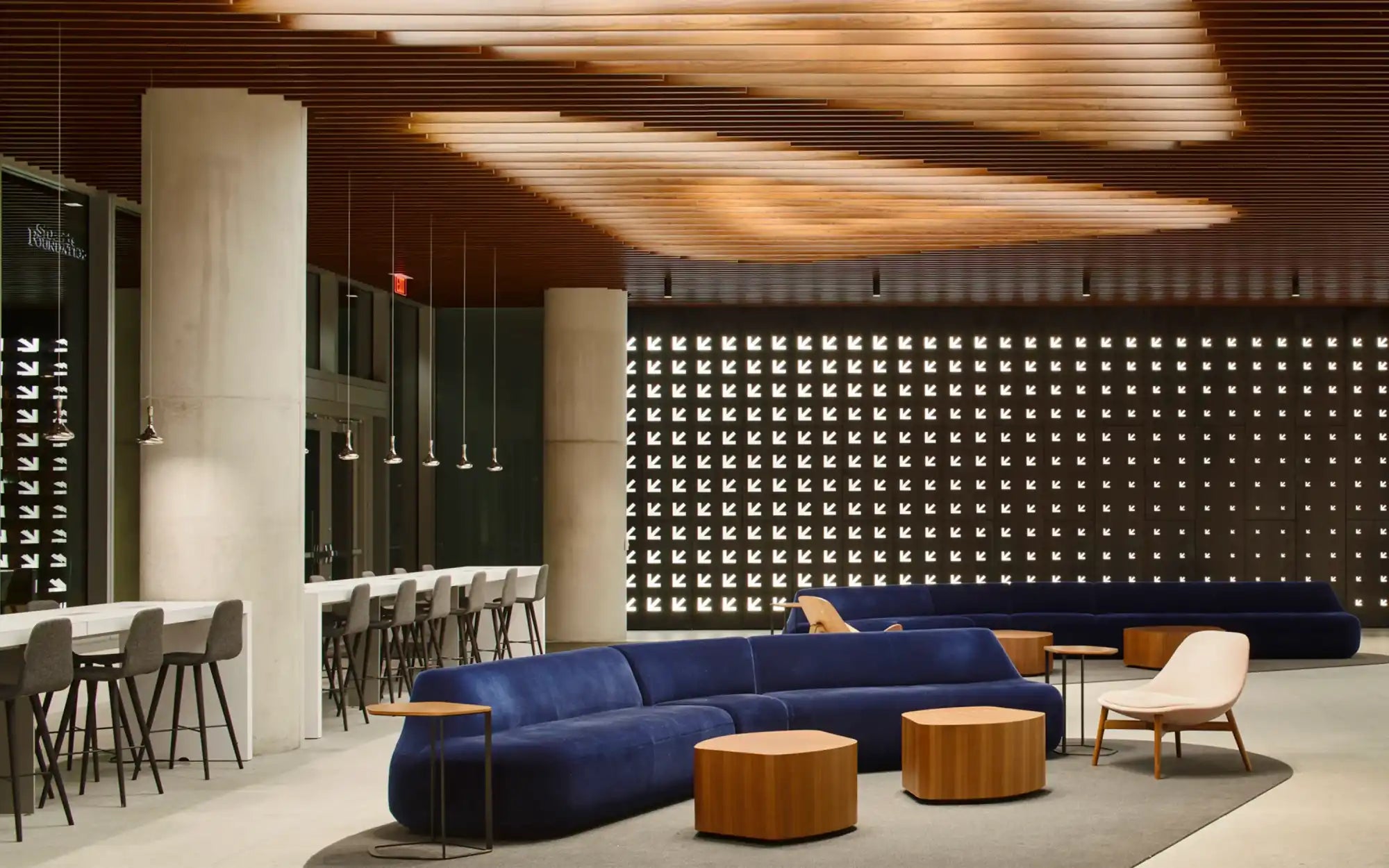 Navy blue sectional sofa with wooden legs and modern design.