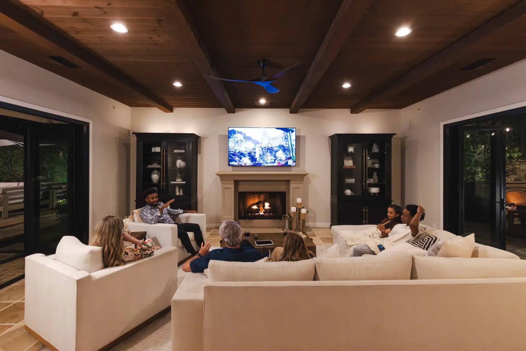 Living room with people watching TV.