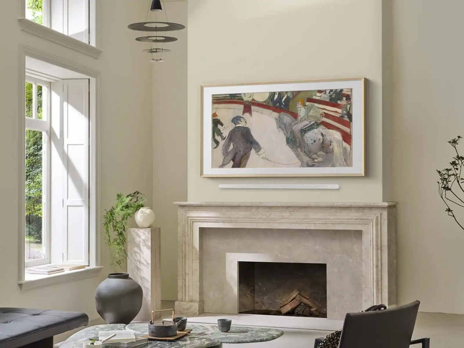 A TV displaying artwork above a fireplace.